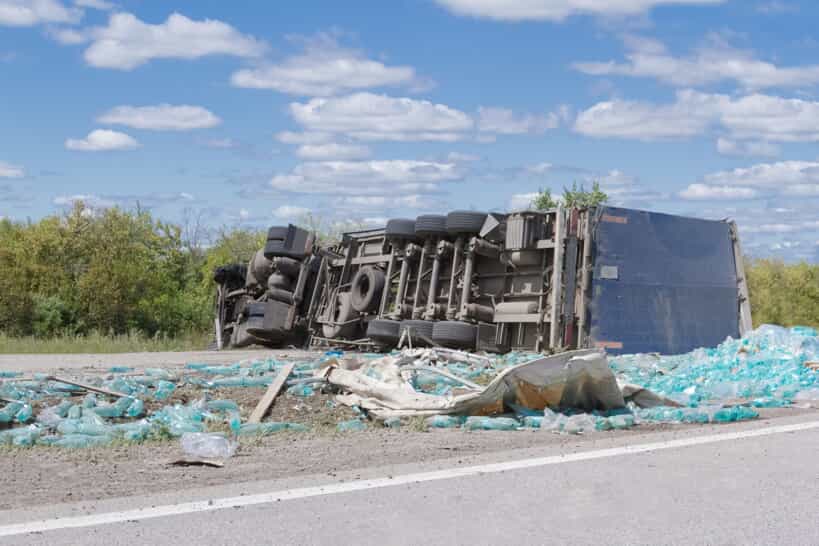 Aftermath of a truck accident with a trailer on its side