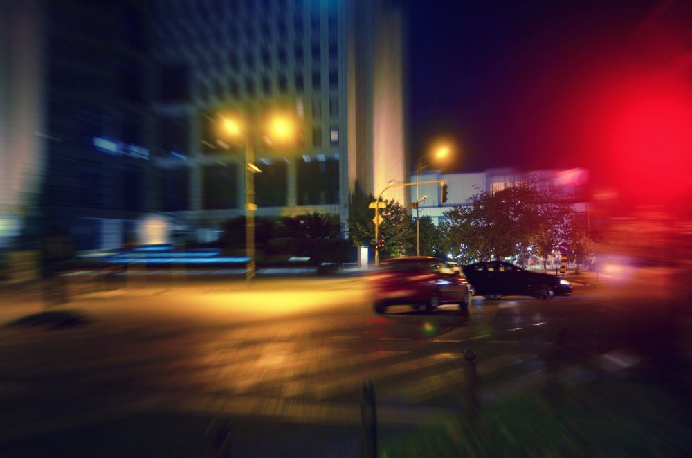 Cars speeding through nighttime streets